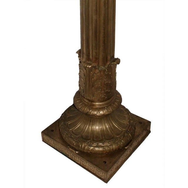 Elegant antique, early 20th century Beaux Arts style fluted column form bronze torchieres having acanthus motifs on bases...