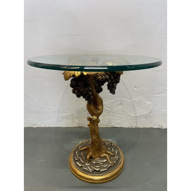The side table has a wooden base with a glass top, dating from the 1960s and made in Italy. It's in lovely used condition...