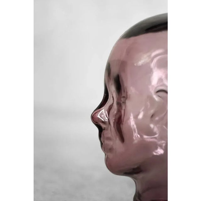 This large glass head was made in Germany during the 1970s. Made of transparent, thick glass in a pink shade. It has a...