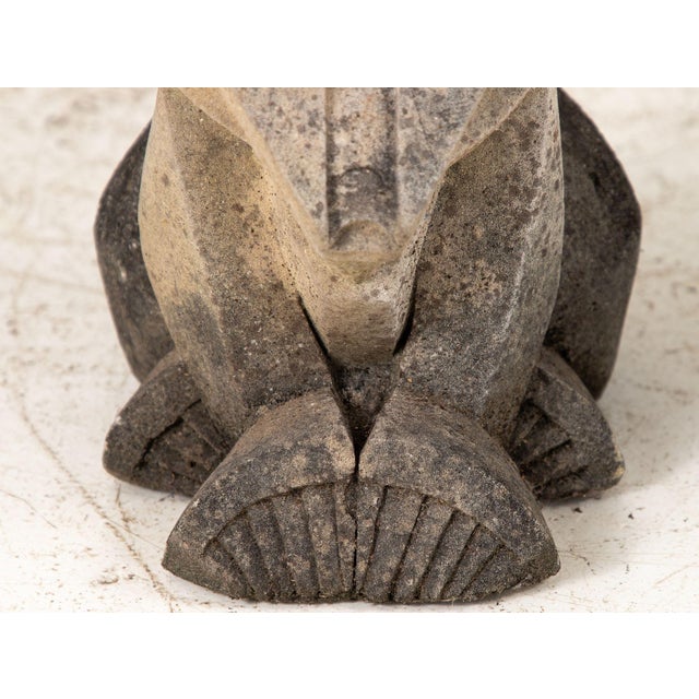 A pair of French concrete lions from the 1930s, embodying the Egyptian influence on Art Deco design. These statues feature...