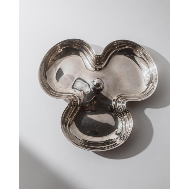 This vintage 1940s silver-plated centerpiece bowl features a beautifully organic, wave-like form with three integrated...