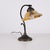 Antique desk lamp made in wrought iron with a yellow frosted glass shade in the style of art nouveau from around the...