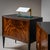 Pair of modern chests of drawers in walnut with ebonized tapered square legs, sides, and tops. The chests feature two...