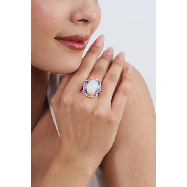This handcrafted cocktail ring features a 9.01-carat Ethiopian opal centerpiece and 18K white gold. The center stone...