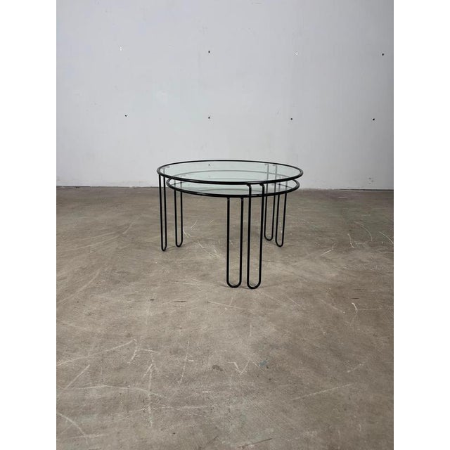 Pair of stacking side tables made of iron and glass — 1970s an elegant pair of stackable coffee tables made of iron and...
