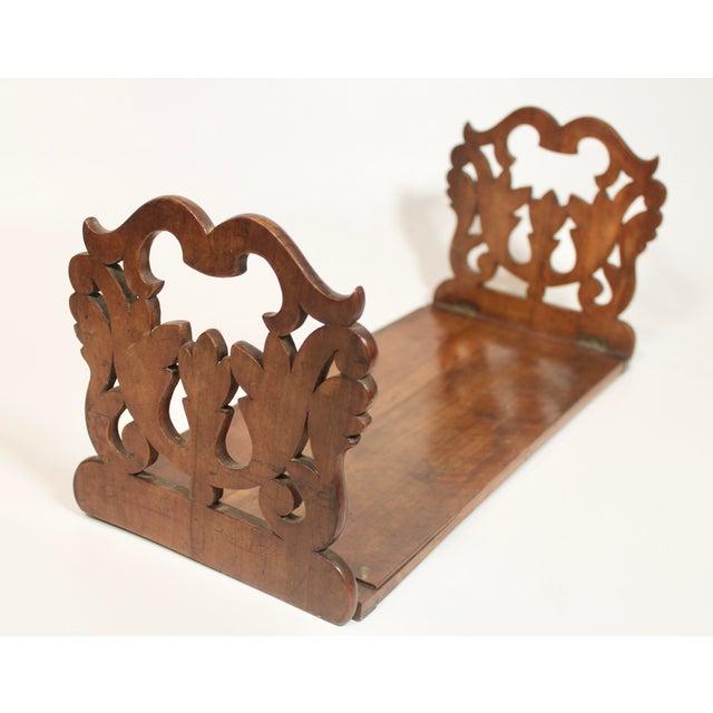 A lovely antique English folding wooden bookshelf, hand carved, circa 1910. This is such a beautiful shelf that is in...