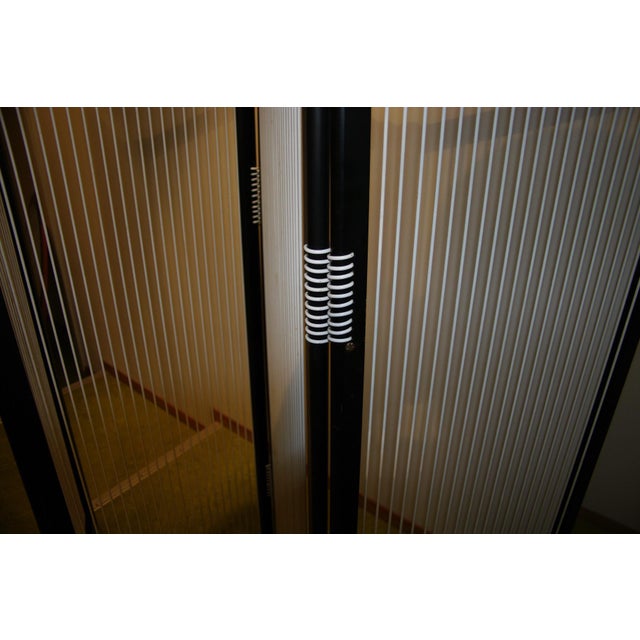 Black lacquered beechwood frame with white plastic lacing (similar to Scoubidou cords). The four panels are connected with...