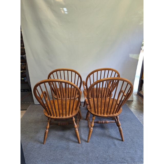 A set of four Mid-century Windsor armchairs with very unique bentwood arms.