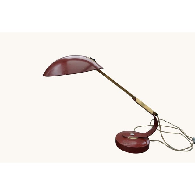 Desk lamp by Ferdinand Solère, France, 1950s. The lamp combines a warm brown, semi-circular metal shade with an adjustable...