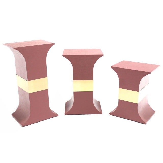 Set of three matching pedestals wrapped in grass cloth in style of Springer. Color customization is possible Dimensions:...