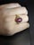 This vintage-style ring showcases a mesmerizing 6.78 carat oval star ruby in a sleek bezel setting, framed by sparkling...