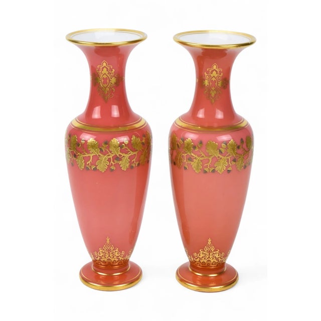 An exquisite pair of Napoleon III period French opaline glass vases in pink with white interiors. They are decorated with...