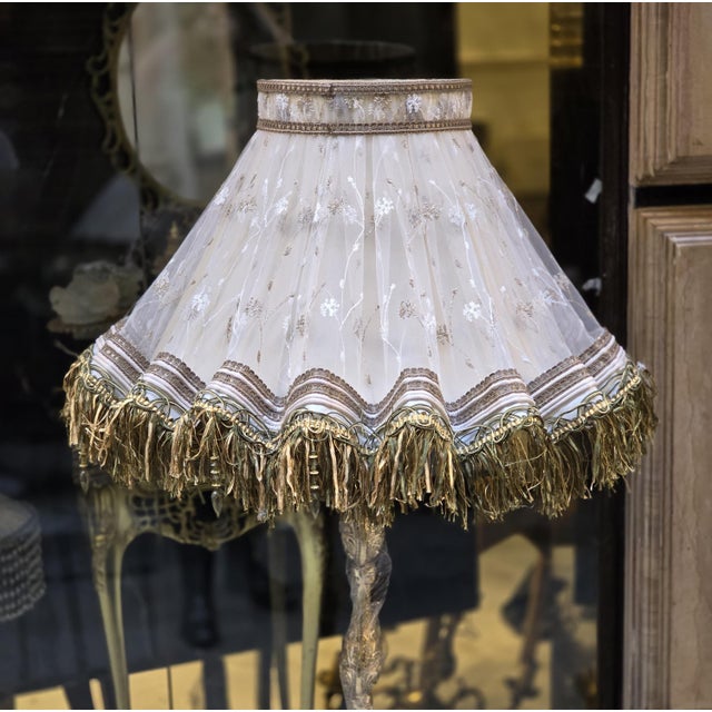 Add a sophisticated European accent to your interior with this ornate gilded floor lamp, featuring an elaborately carved...