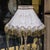 Add a sophisticated European accent to your interior with this ornate gilded floor lamp, featuring an elaborately carved...