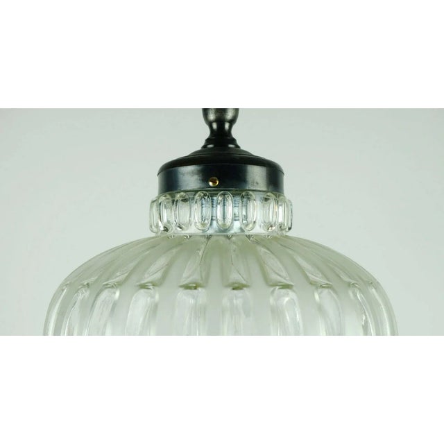 a very nice stylish Mid Century pendant lamp from the 60s. The lampshade is made of structured glass, partly clear glass,...