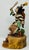 This Hopi Clown Dancer Kachina Doll comes from Native American Milton Howard. Holding a drum and beater, he's stands with...