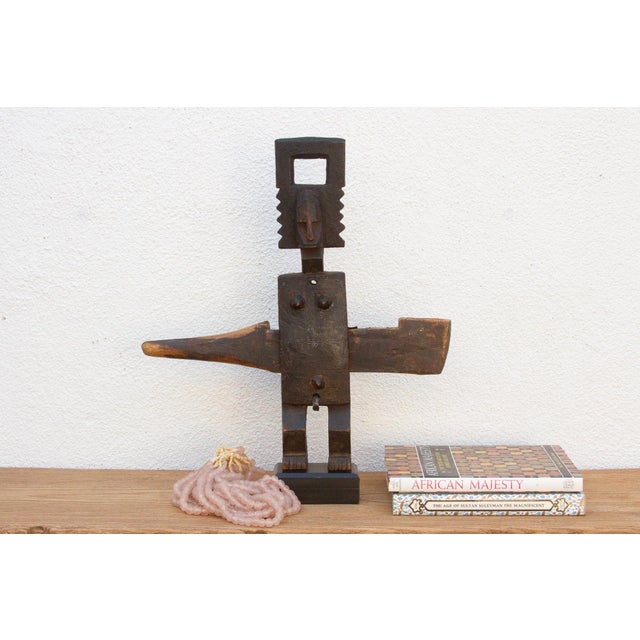 This antique tribal door lock, hand-carved from wood in Mali, Africa, is more than just a functional object; it's a...