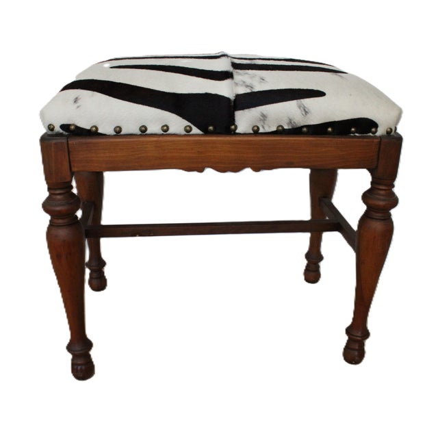 Petite Mid-20th century bench. Newly upholstered with authentic cowhide in a stylish zebra pattern. Carved solid hardwood...
