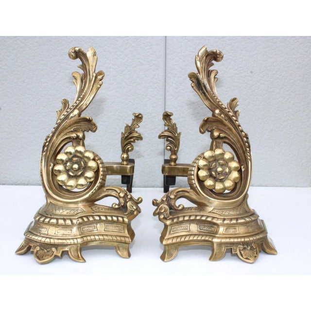Stunning pair of 1950s solid brass French andirons, in vintage condition with minor wear and patina due to age and use.