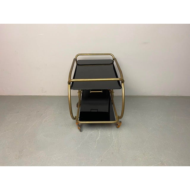 Elegant Mid-Century Brass & Black Glass Bar Trolley by Grünstadt, Germany, 1950s. An elegant vintage bar trolley...