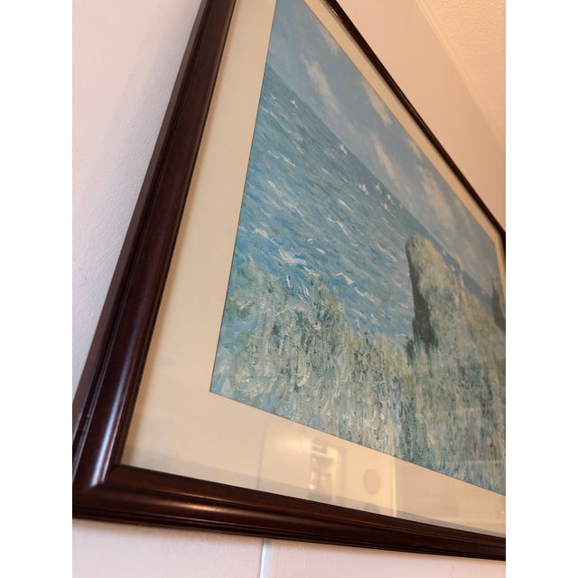Framed art reproduction of Cliff Walk at Pourville by Claude Monet. Classic Impressionist coastal scene with soft blues...