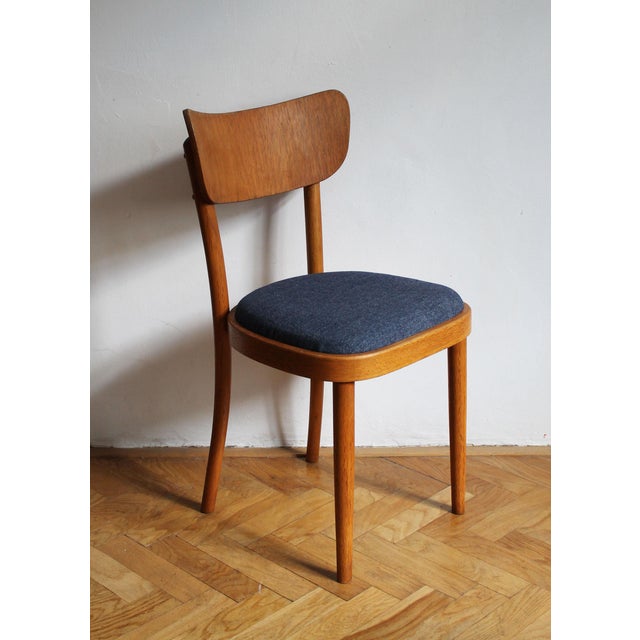 A refined 1960s dining chair by up rousínov, one of czechoslovakia’s important furniture manufacturers. Made in warm-toned...