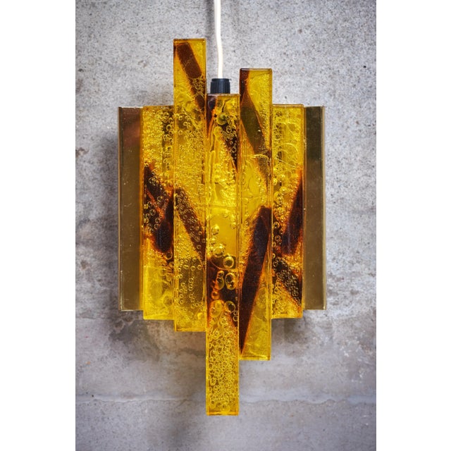 Beautiful pair of wall sconces in brass and crystal glass, danish design, 1960s. Very nice detailed glass. Provides a...