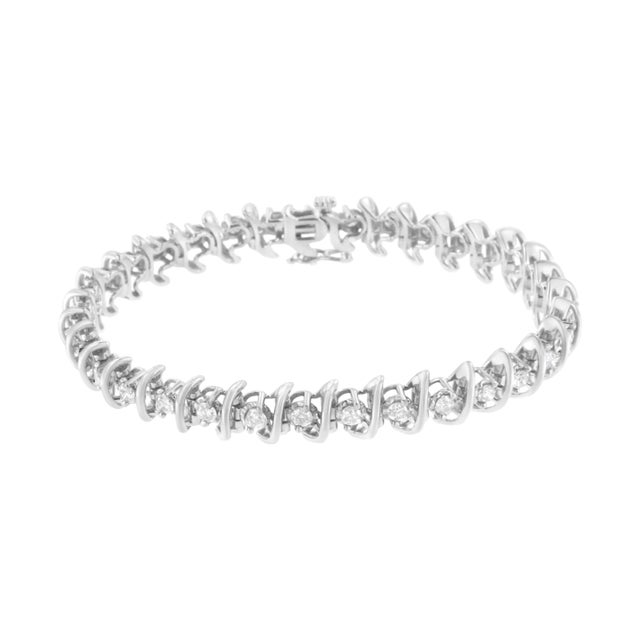 Glistening prong set round cut diamonds are held in between cool links of .925 sterling. This striking bracelet is...