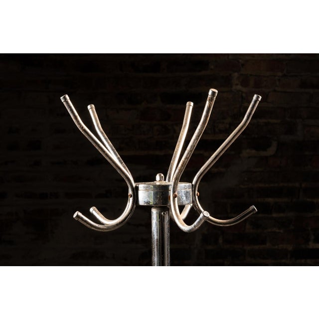 Vintage chrome coat tree on a star base that exudes both practicality and dynamism. This piece features four large double...