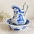 An elegant vintage miniature pitcher and basin set featuring traditional Chinese-inspired landscape decoration in rich...