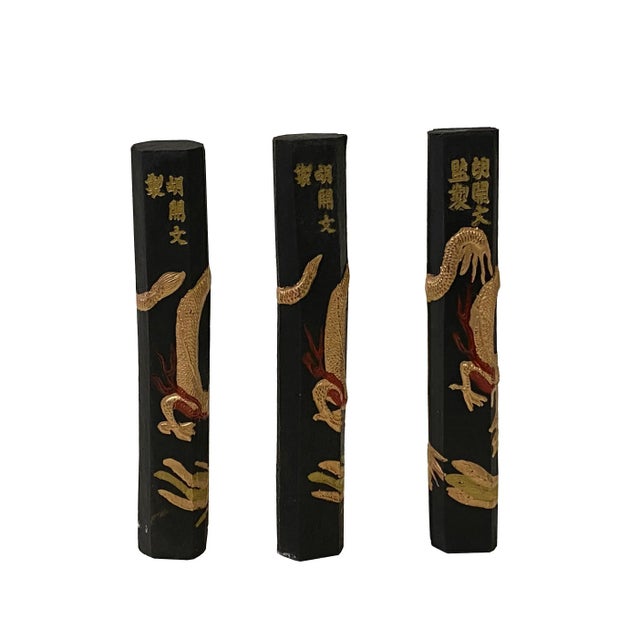 This is a set of 3 Chinese calligraphic black color ink sticks which have all-around dragon phoenix motifs. They both are...