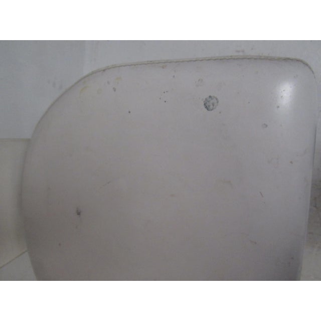 An elegant set of eight Mid-Century Modern high back dining chairs that have an unusual metal base. The sleek design...