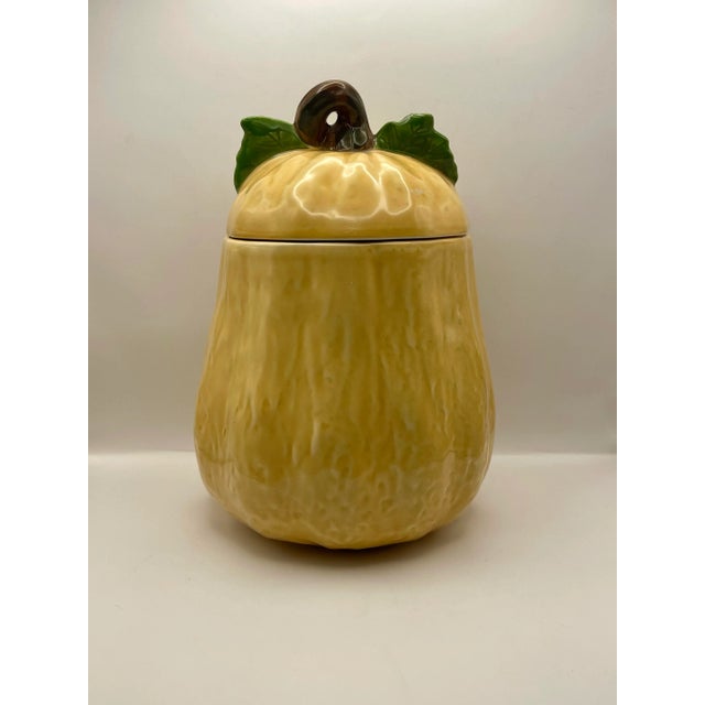 A vintage textured tall squash lidded cookie jar with two leaves and stem.