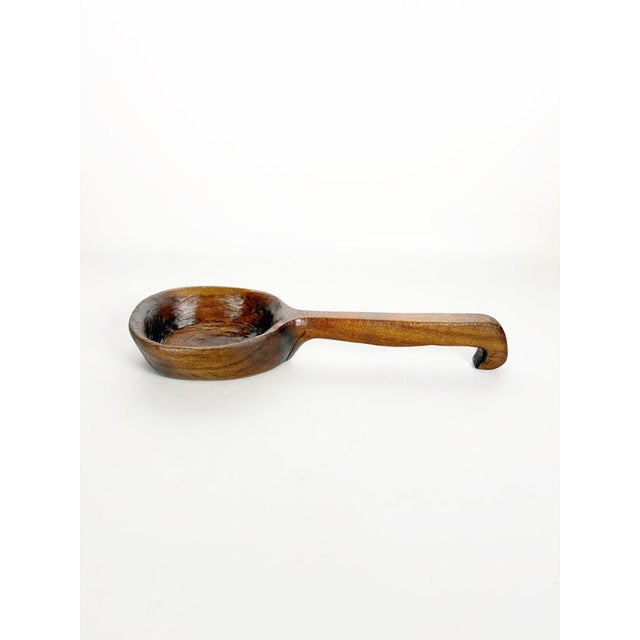 Charming handcrafted wooden ladle from 19th-century France, featuring a beautifully aged patina and a rustic design that...