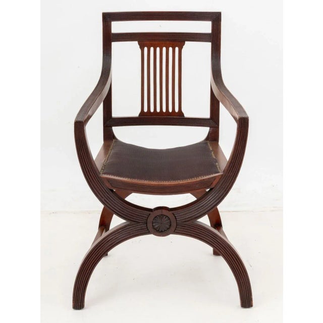 Regency Style Mahogany Armchair, in the manner of Thomas Hope, with pierced back splat on fluted X-frame conjoined by two...