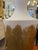 Tall vessel or urn handmade with plaster and other sculpting materials. The vessel is white with gold leaf painted and...
