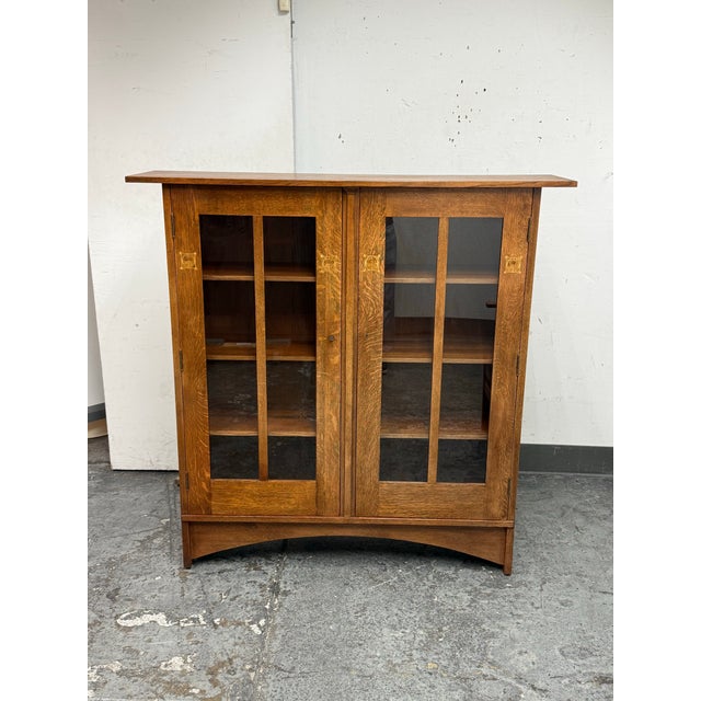 Design Plus Gallery presents a Harvey Ellis Oak Bookcase Cabinet with Inlay from Stickley Furniture, dated Dec. 2010, with...