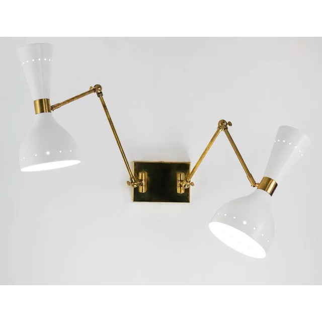 They are called giano, remembering the roman god with two faces. The sconces are attached to the backplate with two hinges...