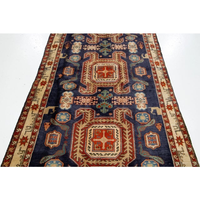 Vintage Handmade Heriz Wool Rug with an allover geometric motif with the blue backdrop. This rug measures 4'3'' x 10'4''.