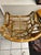 Striking vintage bent rattan lounge chair featuring a sculptural barrel silhouette with dramatic looping armrests and...