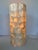 This beautiful handcrafted table lamp is made from natural Capiz shells arranged in a cylindrical form. The translucent...
