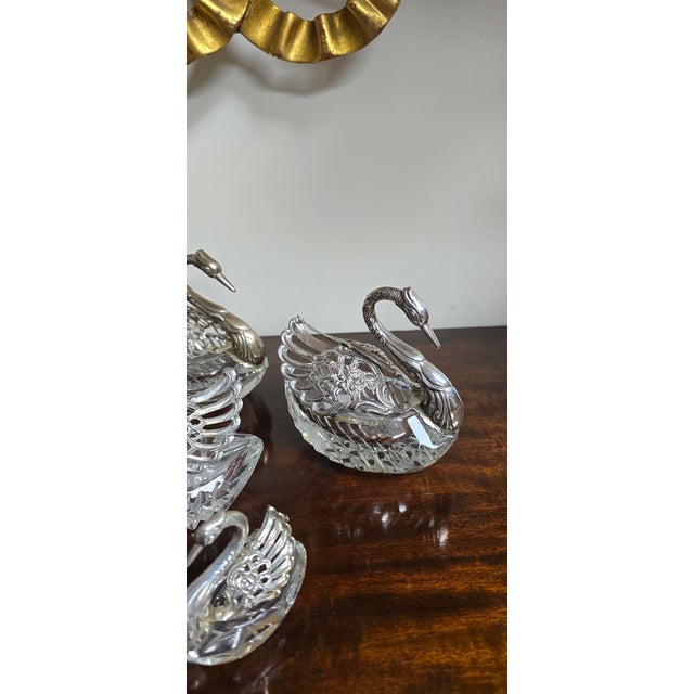Six cut glass and hallmarked silver swans, three large, one medium and two small, pivoting wings, all in excellent overall...