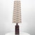 A brown ceramic floor lamp with circular pattern. Sculptural piece, made of handmade ceramic in warm tones, with a new...