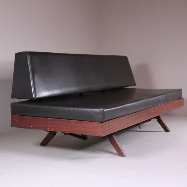 Black Vinyl and Wood Sofa, 1970, in Worn conditions. Designed 1970 to 1979