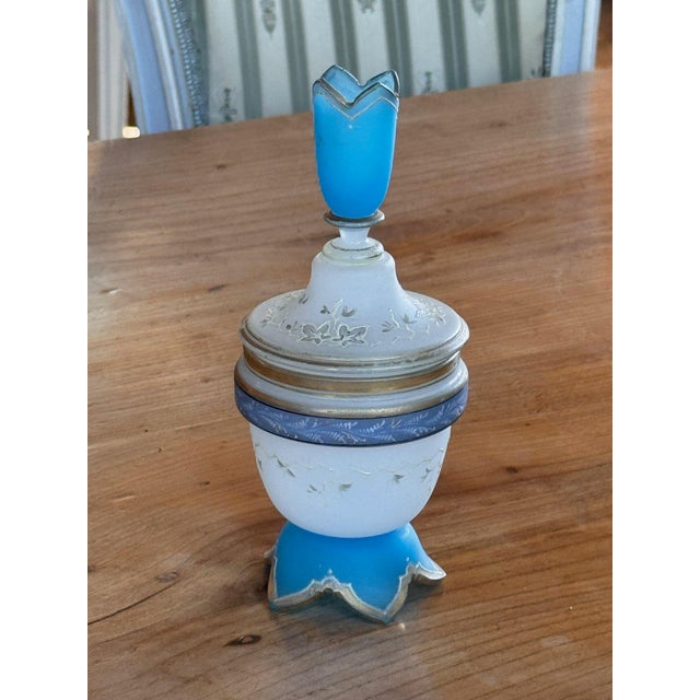 19th century French blue and white opaline glass dresser jar. The frosted white bowl is painted with a trailing vine and...