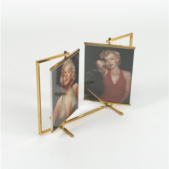 Midcentury amazing swivel double picture frame in brass and acrylic in the style of Paul Lobel. The double frame swivels...