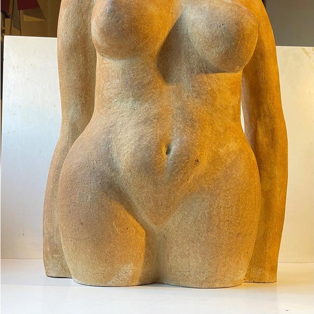 A lush sculptural depicting of a nude female torso. Executed in burnt terracotta stoneware. Bought in and anonymously made...