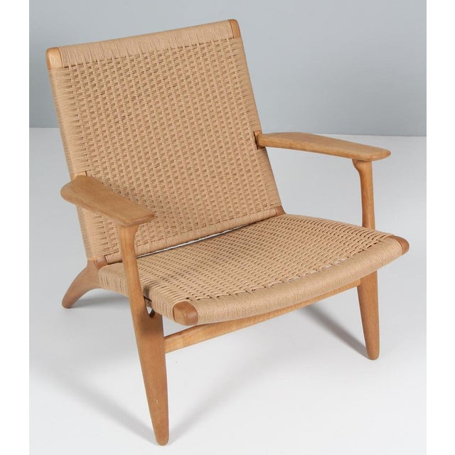 Hans J. Wegner CH-25 lounge chair, 1950 Produced by Carl Hansen & Son, Copenhagen, Denmark. Oiled, patinated oak frame...