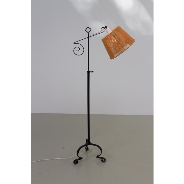 Swedish Design Tripod Floor Lamp in Forged Iron, 1940s. A sculptural hand-crafted floor lamp in black painted wrought and...