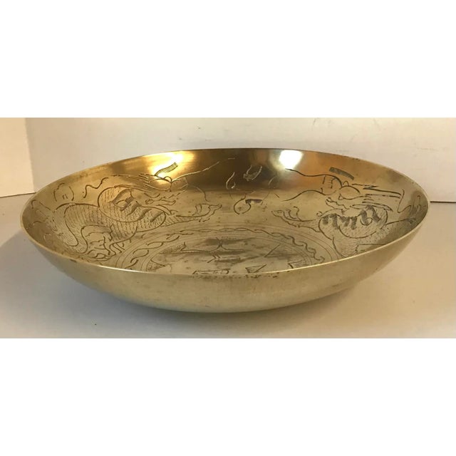 Nice vintage brass bowl with dragon etched design inside. Signed on back.